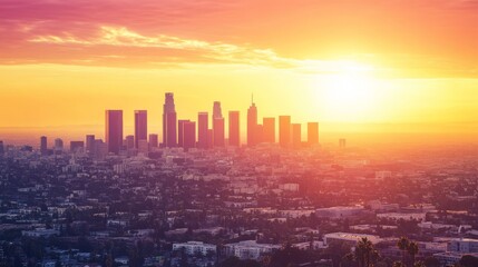 The city of Los Angeles looks beautiful as the sun starts to set, casting a warm glow on the buildings.