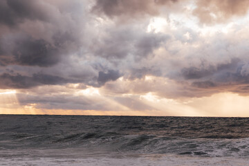 Beautiful landscape stormy sea and sky at sunset with clouds