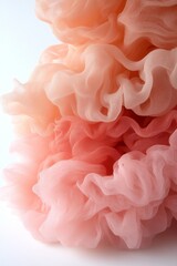 Fototapeta premium A close up of a pink and peach colored fabric on a white surface