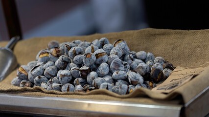 Closeup of rot roast chestnuts on a street venders cart