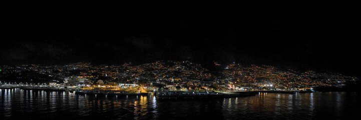 Panorama of the cruise port and city of Funchal at night from a cruise ship