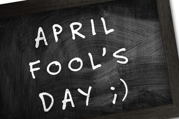 Fototapeta premium Chalkboard with text April Fool's Day on wite background. 1st April celebration