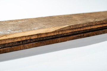 Closeup view of wood plank stack isolated over white background. Natural wooden texture