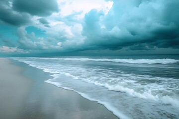 The sea is calm with a cloudy sky over the beach