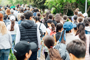 Crowd Lots of people walking down the road in spring