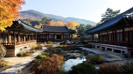 Obraz premium Korean architecture with a traditional courtyard view, showcasing a serene pond and colorful autumn trees.