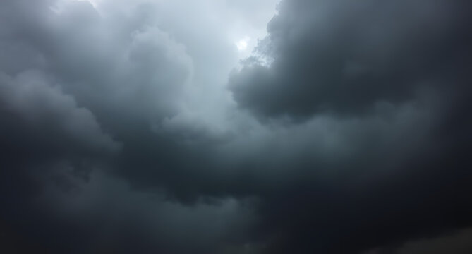 Dark storm clouds rolling in background. Heavy gray formations gathering ominously