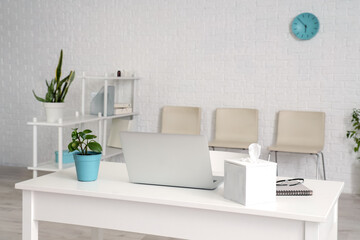 Interior of modern clinic with workplace and chairs