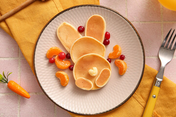 Funny Easter bunny pancakes on pink tile background