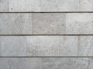 Background in the form of an old wall of white and gray color made of concrete with square and rectangular lines