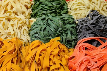 A vibrant and colorful assortment of fresh pasta nests, showcasing a variety of hues and textures, promising a delicious and visually appealing culinary experience.