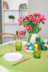 Beautiful table serving with red tulips for Easter celebration