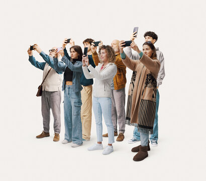 Large group of ordinary people taking photos with smartphones