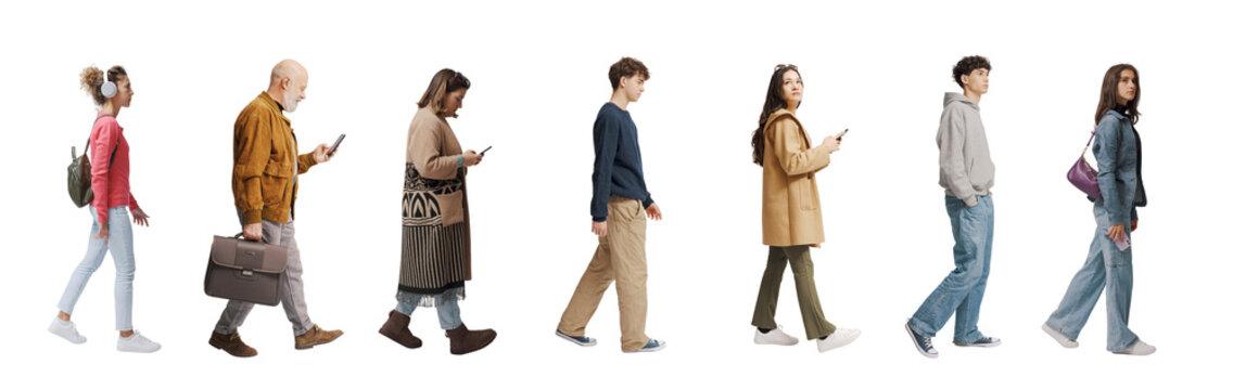 A group of ordinary people of mixed ages walk by looking around curiously as tourists in a new place