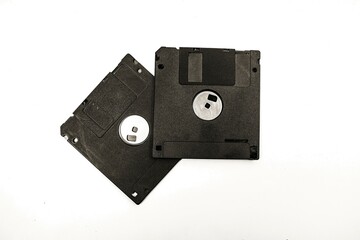 Two black floppy disks on a white background
