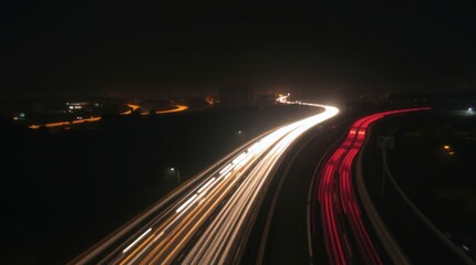 Fototapeta premium Highway Nightscape with Car Light Trails Speeding Along Dark Road