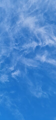 Vertical blue sky photography with white clouds