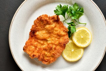 Schnitzel served with lemon and leaves of parsley