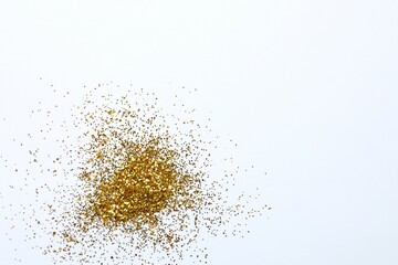 Beautiful shiny gold glitter on white background, top view