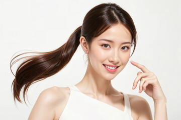 A woman with long brown hair and a ponytail is smiling and posing for a picture