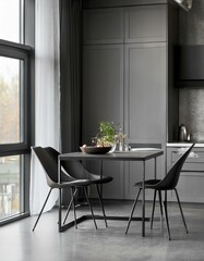 Fototapeta premium Grey kitchen interior with table and chairs near window on concrete floor