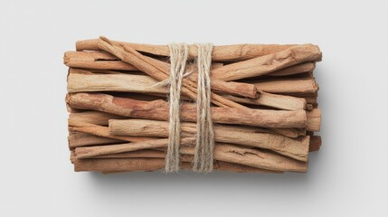 Bundle of cinnamon sticks tied with twine on white background