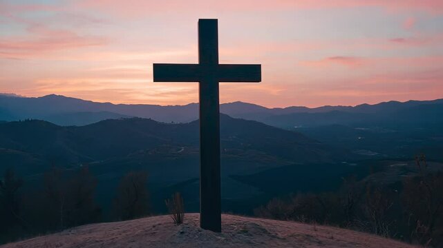 Scenic view of a cross at sunset overlooking mountains and valleys in a tranquil landscape