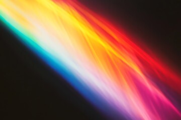 Obraz premium Abstract vibrant rainbow light streaks on black background.