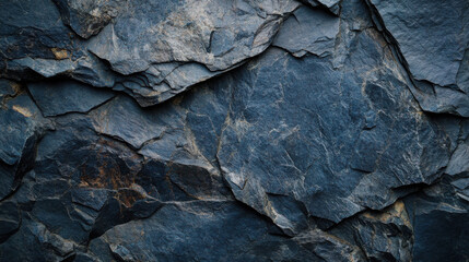 A dark blue slate rock texture with rough, cracked stone layers, creating a rugged, natural surface perfect for nature, geology, or abstract design projects.