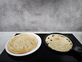 Cooking crepes for shrove tuesday or pancake day, maslenitsa or breakfast celebration in prague copy space