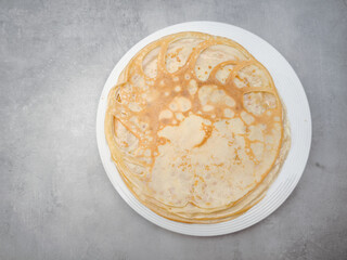 Delicious homemade crepes served on a plate, celebrating pancake day or maslenitsa copy space