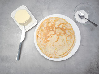 Celebrating pancake day with delicious homemade crepes, butter, and sugar in prague for shrove tuesday, maslenitsa or breakfast