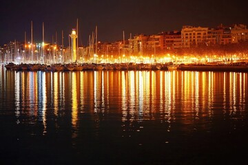 Fototapeta premium A nighttime harbor scene with lights reflected in the water