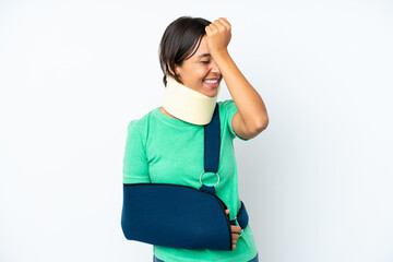 Young hispanic woman wearing a neck brace and sling isolated on white background has realized...