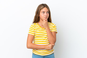 Little caucasian girl isolated on white background thinking an idea while looking up