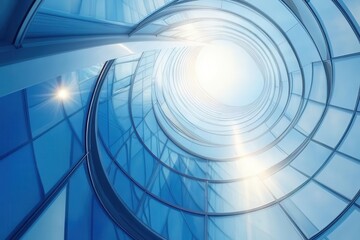 modern glass skyscraper spiral staircase viewed from below creating geometric patterns with sunlight streaming through windows
