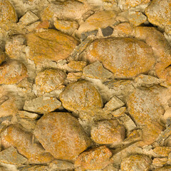 An old stone wall. Background of yellow stones. Stone texture. Yellow stones. Seamless.
