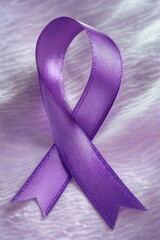 A purple ribbon lying on top of a bed