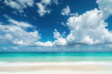 A serene coastal scene with a clear blue ocean and a sandy beach in the foreground