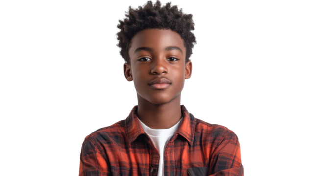 Young boy in flannel shirt with confident expression stands against a plain background