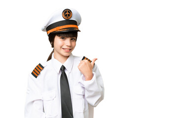 Little girl as a Airplane pilot over isolated chroma key background pointing to the side to present a product