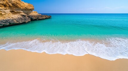 Obraz premium Tranquil Beach with Crystal Clear Water and Soft Sand under Bright Blue Sky
