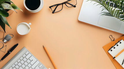 A minimalist workspace featuring a laptop, stationery, and plants on an orange desk background