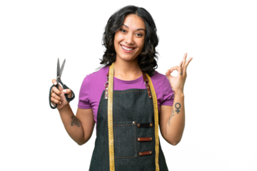 Young seamstress argentinian woman over isolated background showing ok sign with fingers