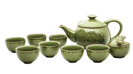 Teapot set with intricate green designs displayed with matching cups in an elegant arrangement