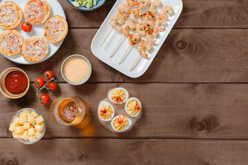 Assorted Party Snacks and Drinks on Wooden Table