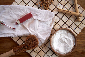 Removing coffee and lipstick stains from a white shirt with eco-friendly products, top view