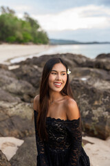 Young woman on the beach smiling