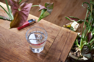 there's a glass of water on the table with a red lipstick imprint on it