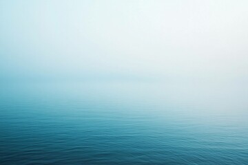 Obraz premium Serene blue seascape with tranquil water and soft gradient, perfect for relaxation and mindfulness themes Calm ocean atmosphere is reflected in muted tones